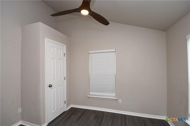 unfurnished room featuring vaulted ceiling, baseboards, a ceiling fan, and dark wood-type flooring