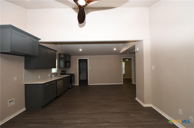 kitchen featuring light countertops, ceiling fan, dark wood-style floors, and a sink