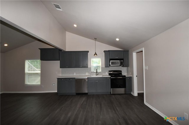 kitchen with vaulted ceiling, stainless steel appliances, a sink, and visible vents