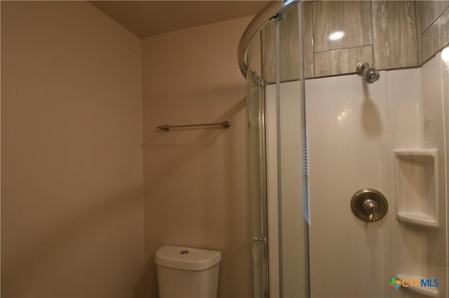 full bath with a stall shower and toilet