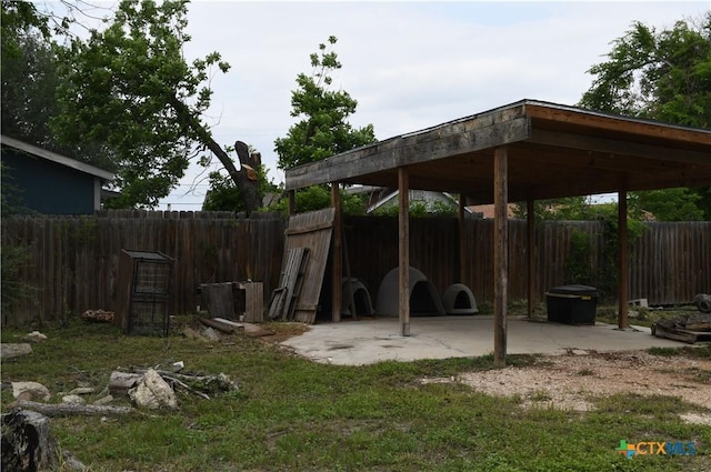 view of yard with a fenced backyard and a carport
