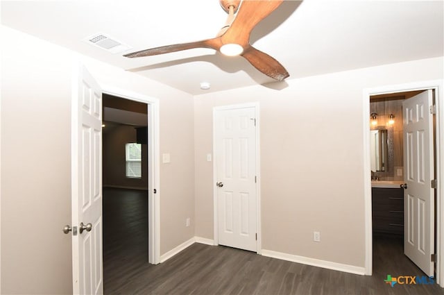 unfurnished bedroom with visible vents, baseboards, dark wood-type flooring, and ceiling fan