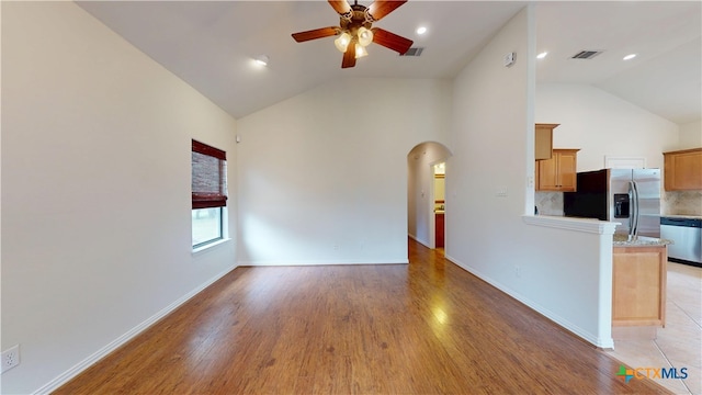 1802 Spring Valley Dr, Dripping Springs, TX 78620 - unfurnished living room featuring ceiling fan, arched walkways, light wood-style flooring, high vaulted ceiling, and recessed lighting