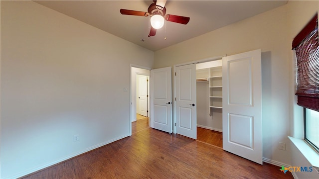 1802 Spring Valley Dr, Dripping Springs, TX 78620 - unfurnished bedroom with wood finished floors, a closet, and ceiling fan