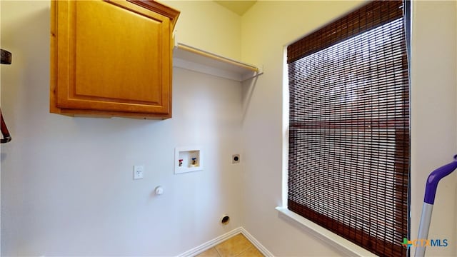 1802 Spring Valley Dr, Dripping Springs, TX 78620 - laundry area with hookup for a washing machine, cabinet space, hookup for an electric dryer, and light tile patterned floors