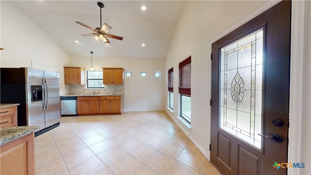 1802 Spring Valley Dr, Dripping Springs, TX 78620 - kitchen with stainless steel appliances, decorative backsplash, ceiling fan, light stone countertops, and plenty of natural light