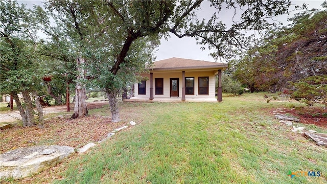 1802 Spring Valley Dr, Dripping Springs, TX 78620 - back of house featuring a lawn