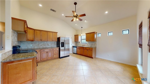 1802 Spring Valley Dr, Dripping Springs, TX 78620 - kitchen featuring appliances with stainless steel finishes, ceiling fan, tasteful backsplash, brown cabinets, and light stone countertops