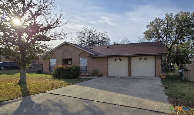 ranch-style home with a garage and a front lawn