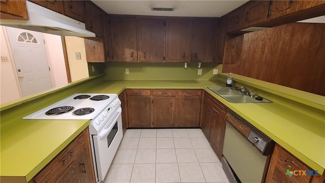 kitchen featuring dishwasher, light tile patterned floors, electric range, and sink