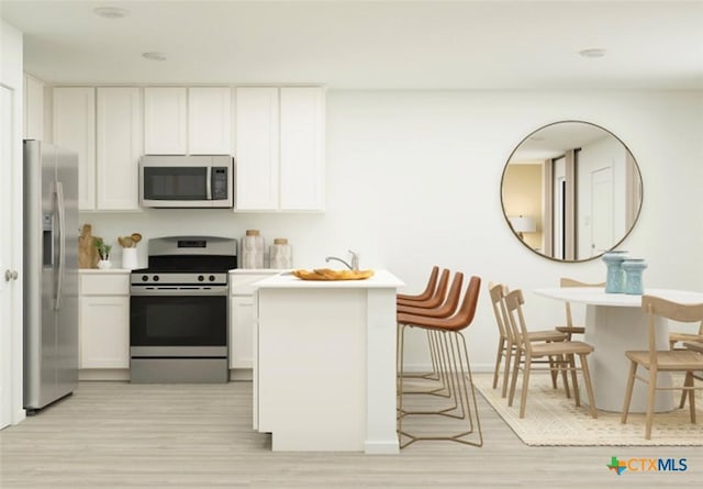 522 Bonzo Ct, Jarrell, TX 76537 - kitchen featuring white cabinetry, light wood-type flooring, and appliances with stainless steel finishes
