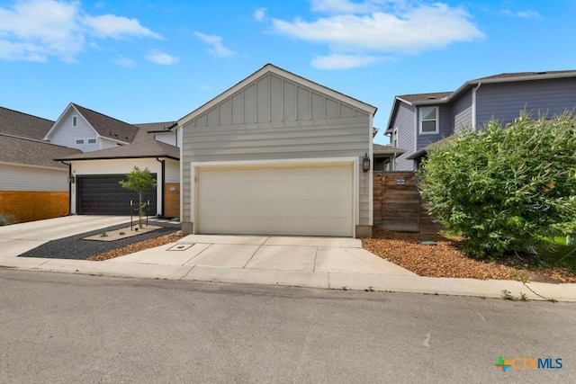 view of front of home featuring an attached garage, board and batten siding, and driveway