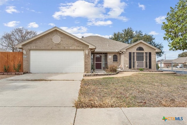 single story home featuring a garage and a front yard