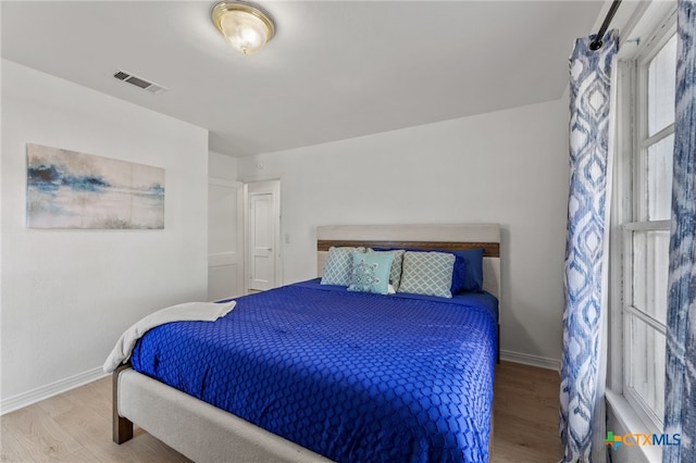 bedroom with hardwood / wood-style flooring