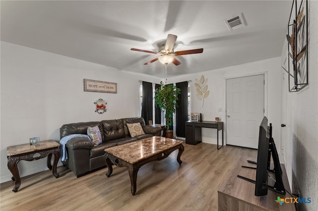 living room featuring ceiling fan and light wood-type flooring