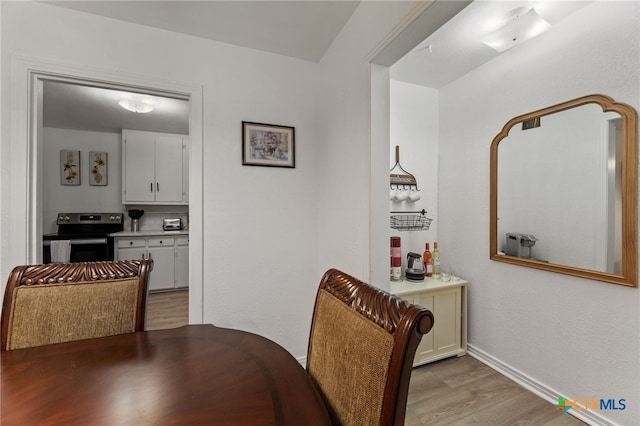 dining area featuring light wood-type flooring