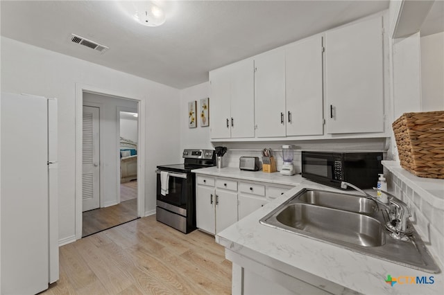 kitchen featuring stainless steel range with electric stovetop, sink, white refrigerator, light hardwood / wood-style flooring, and white cabinetry