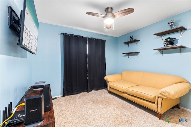 living room with a ceiling fan and baseboards