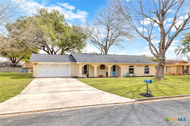 ranch-style house featuring an attached garage, fence, concrete driveway, and a front yard