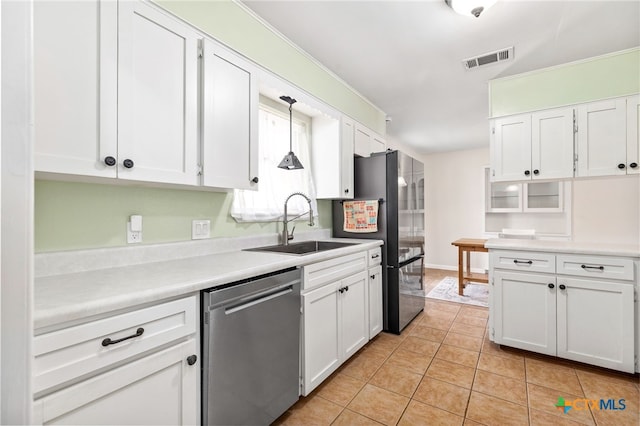 kitchen with light tile patterned floors, stainless steel appliances, visible vents, and white cabinetry