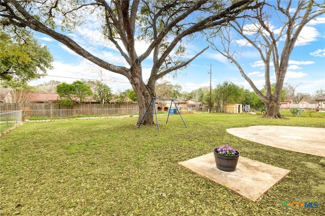 view of yard with a fenced backyard and a playground