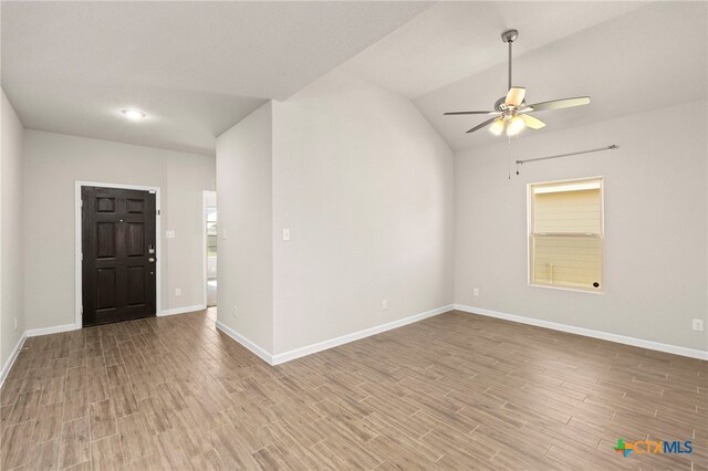 entrance foyer featuring ceiling fan, light wood-type flooring, and vaulted ceiling