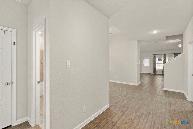 corridor featuring hardwood / wood-style floors