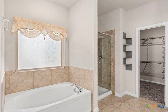 bathroom featuring tile patterned flooring and separate shower and tub