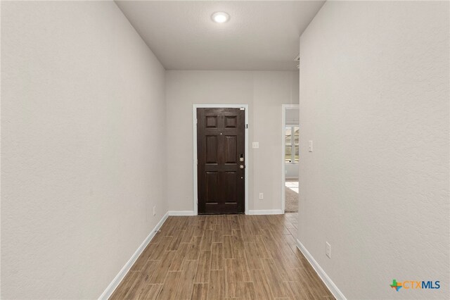 corridor featuring light hardwood / wood-style floors