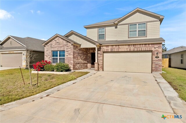 craftsman-style home with a garage and a front lawn