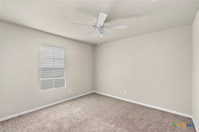 unfurnished room with ceiling fan and carpet floors