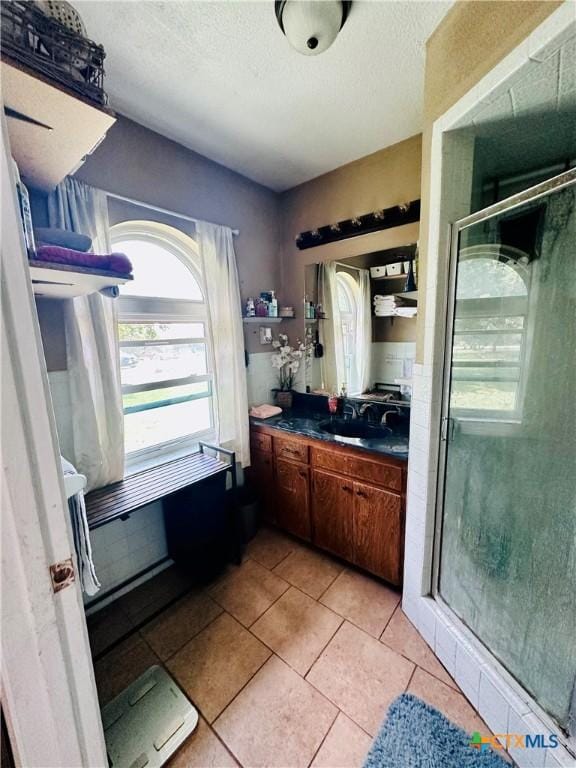 3043 Boys Ranch Rd, Kempner, TX 76539 - bathroom with a shower stall, vanity, tile patterned flooring, and a textured ceiling