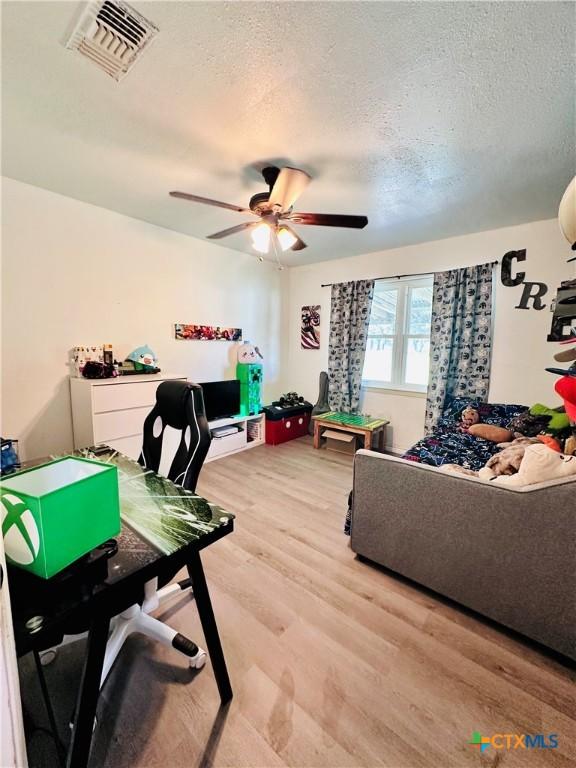 3043 Boys Ranch Rd, Kempner, TX 76539 - home office featuring light wood finished floors, ceiling fan, and a textured ceiling