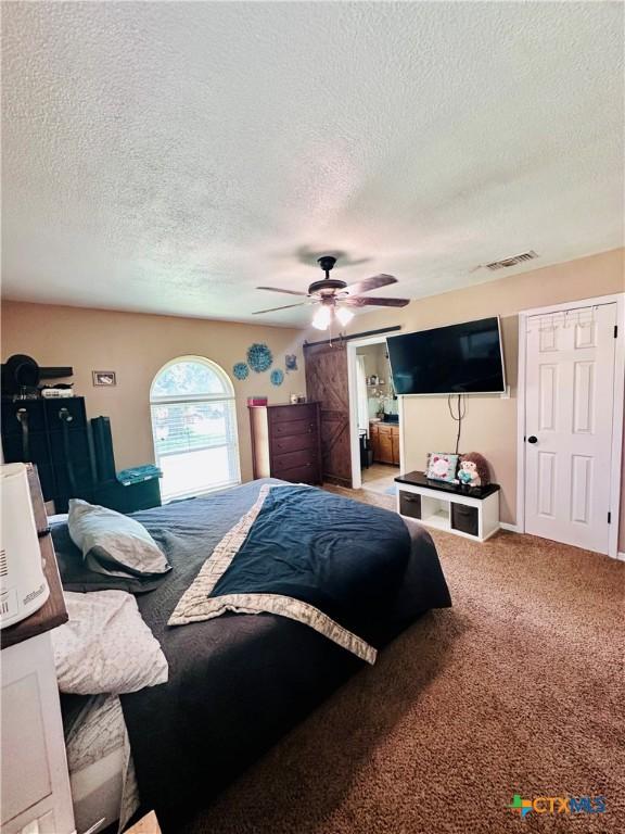 3043 Boys Ranch Rd, Kempner, TX 76539 - bedroom with a textured ceiling, carpet, and a ceiling fan