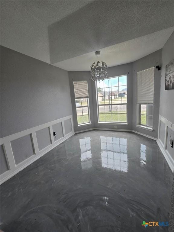 2814 Blackburn Dr, Killeen, TX 76543 - unfurnished dining area featuring finished concrete floors, a chandelier, and a textured ceiling
