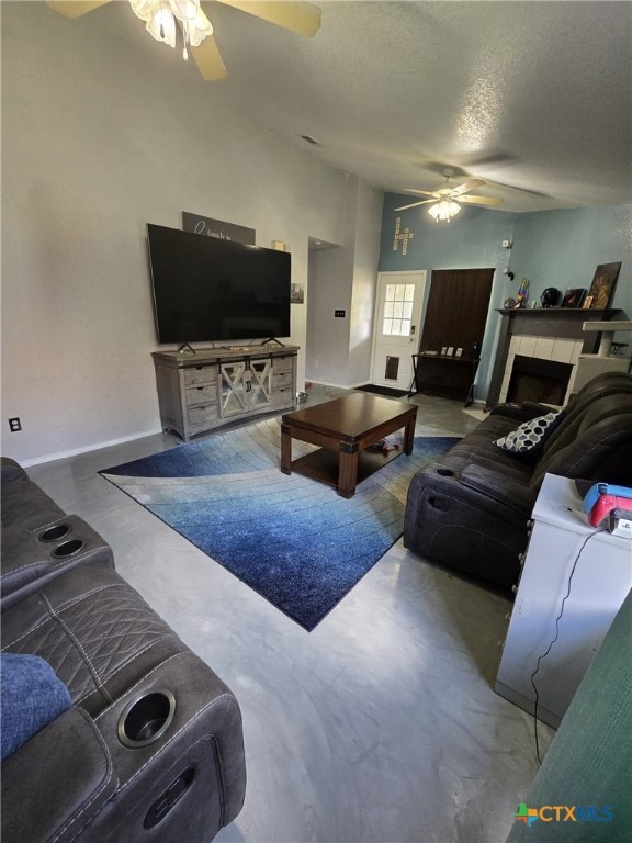 2814 Blackburn Dr, Killeen, TX 76543 - living room featuring ceiling fan, finished concrete floors, a textured ceiling, and a fireplace