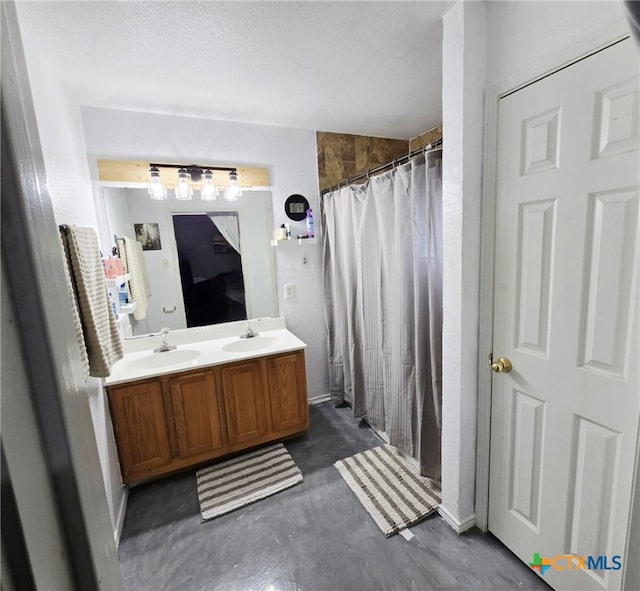 2814 Blackburn Dr, Killeen, TX 76543 - bathroom featuring double vanity, concrete flooring, curtained shower, and a textured ceiling