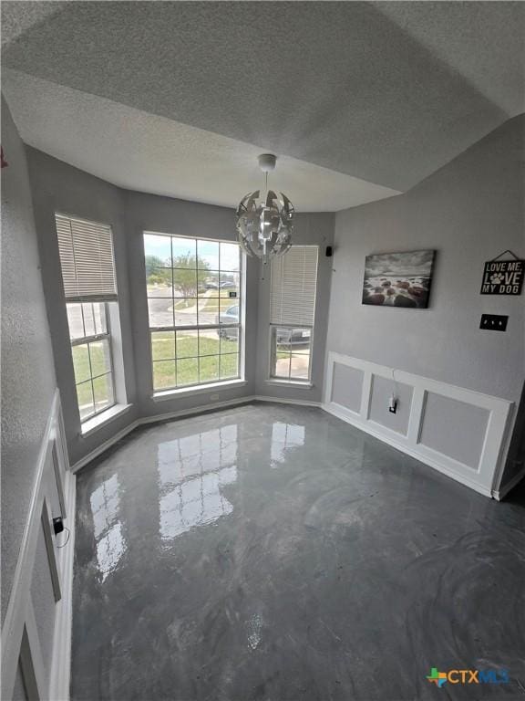 2814 Blackburn Dr, Killeen, TX 76543 - unfurnished dining area with concrete floors, a chandelier, and a textured ceiling
