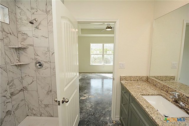 bathroom featuring concrete flooring, vanity, and tiled shower