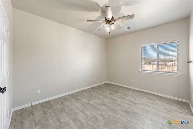 unfurnished room with ceiling fan, visible vents, and baseboards