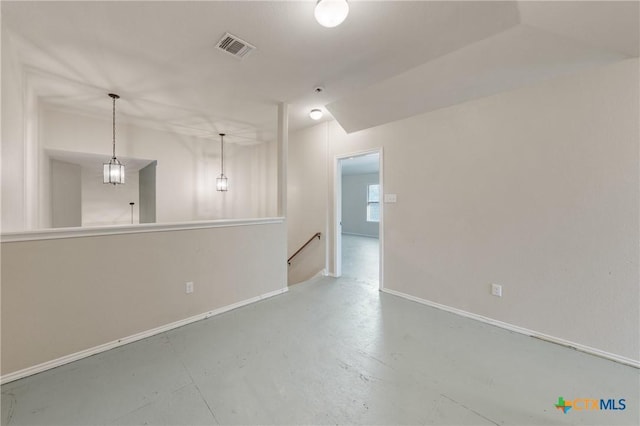 spare room with concrete floors, visible vents, and baseboards