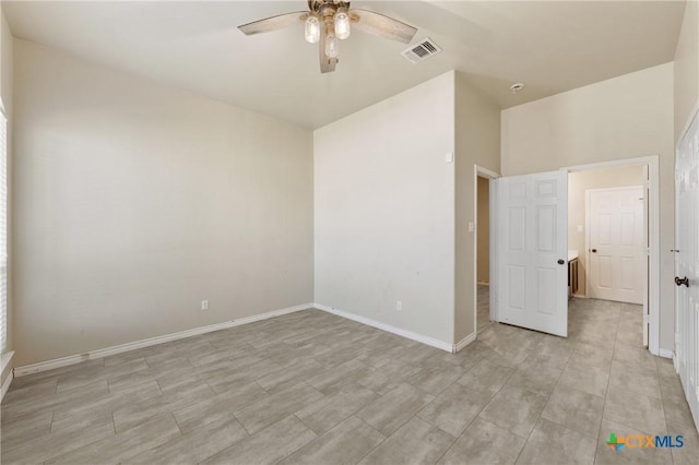 unfurnished bedroom featuring a ceiling fan, visible vents, and baseboards