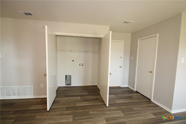 washroom with washer hookup, wood finished floors, and visible vents