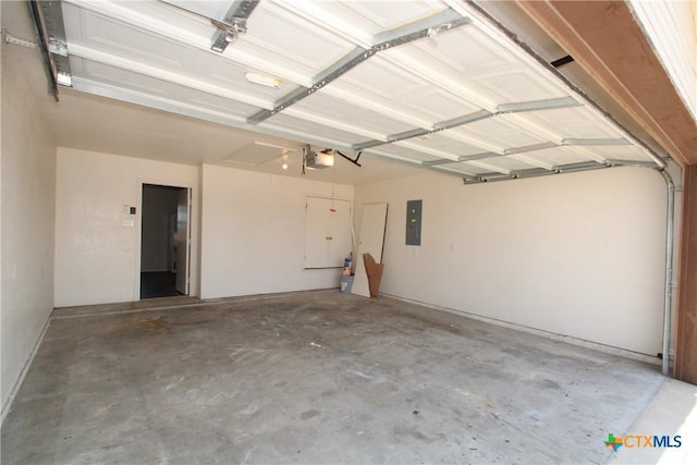 garage with a garage door opener and electric panel