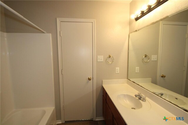 bathroom featuring vanity and shower / tub combination