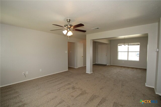 unfurnished bedroom featuring visible vents, carpet floors, multiple closets, baseboards, and ceiling fan with notable chandelier