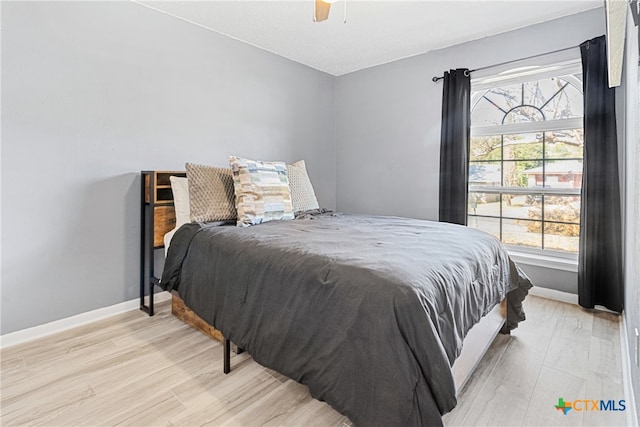 bedroom featuring light hardwood / wood-style floors and ceiling fan