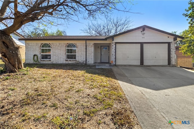 single story home featuring a garage and a front lawn