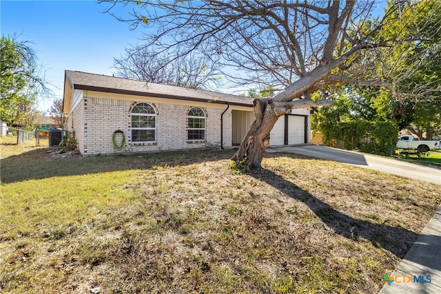 ranch-style home featuring a garage and a front yard