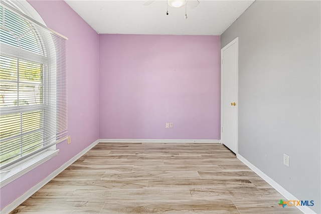 unfurnished room featuring light hardwood / wood-style flooring, a healthy amount of sunlight, and ceiling fan